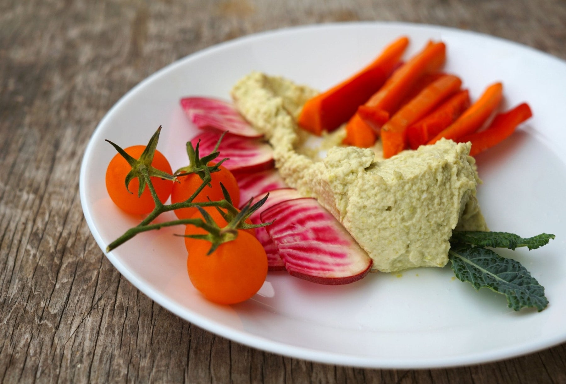 Plate of vegetables with High Protein Edamame Hummus - organicfair.com