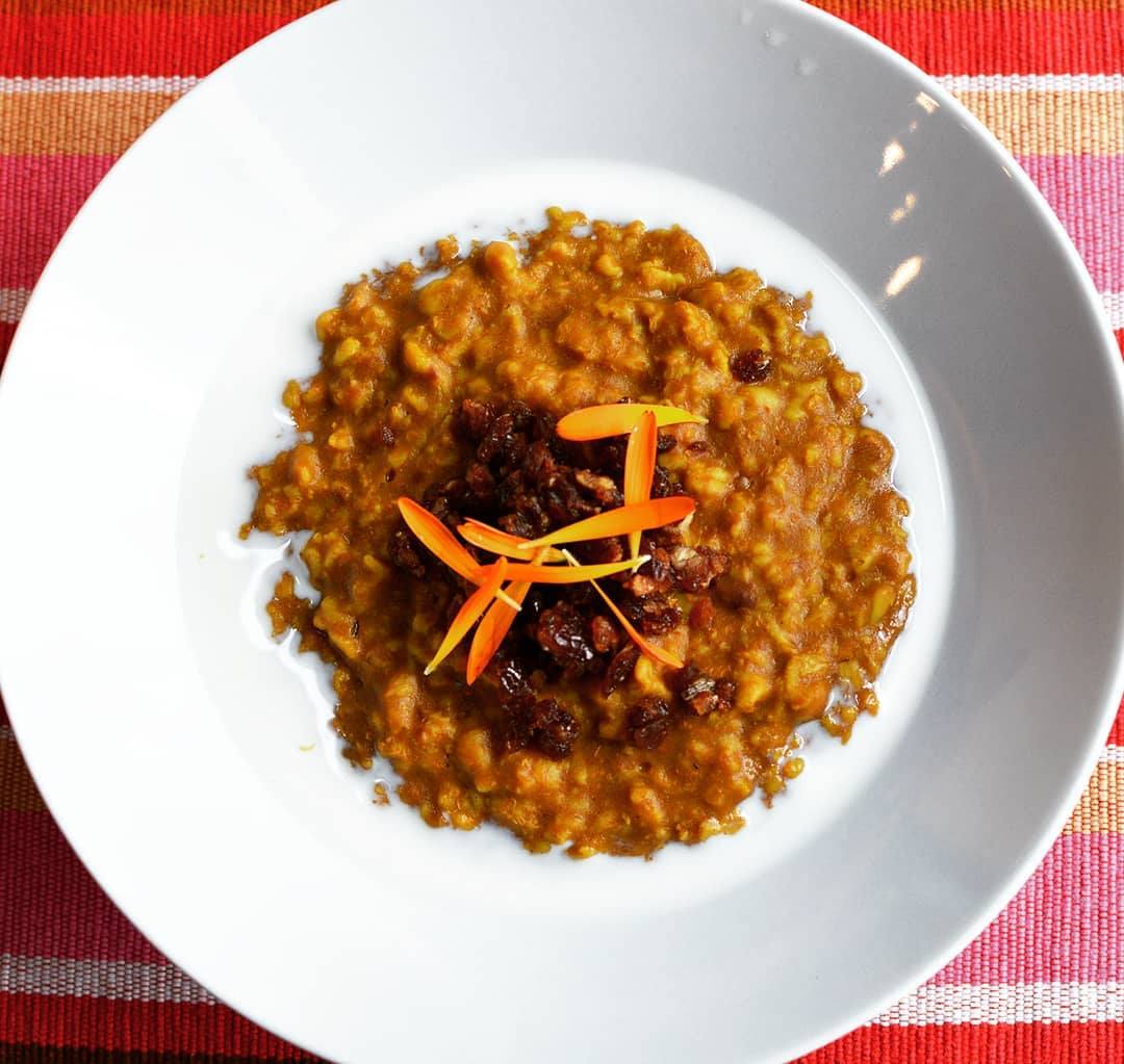 Pumpkin Goldenmilk Oatmeal in bowl with chopped dates on top - organicfair.com