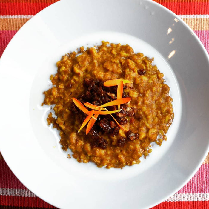 Pumpkin Goldenmilk Oatmeal in bowl with chopped dates on top - organicfair.com